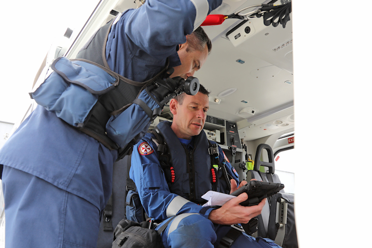 A pilot and paramedic on board Toll Helicopter' AW139 (VH-TJK 'Rescue 204') discuss an upcoming mission to rescue a patient. (Paul Sadler)