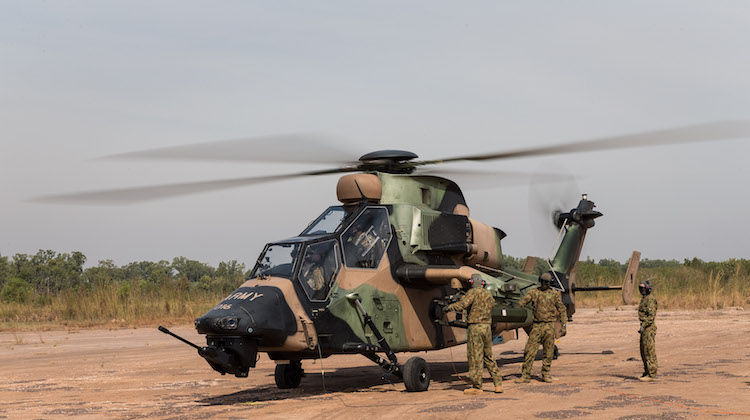 Australian Army soldiers from 1st Aviation Regiment prepare a Tiger Armed Reconnaissance Helicopter for flight at the Forward Arming and Refuelling Point in Robertson Barracks, Darwin.
