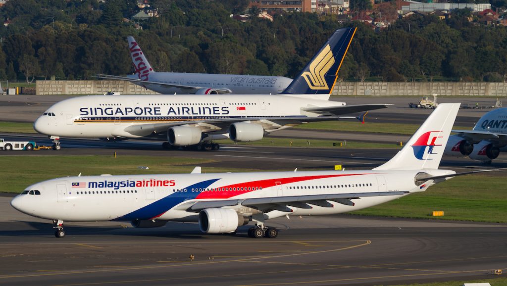 A Malaysia Airlines Airbus A330 and Singapore Airlines A380 at Sydney Airport. (Seth Jaworski)